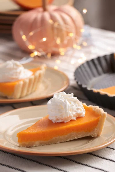 stock image Fresh homemade pumpkin pie with whipped cream on table