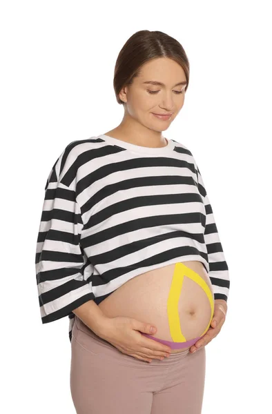 Pregnant Woman Kinesio Tapes Her Belly White Background — Stock Photo, Image