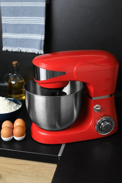 Modern stand mixer and ingredients on countertop in kitchen. Home appliance