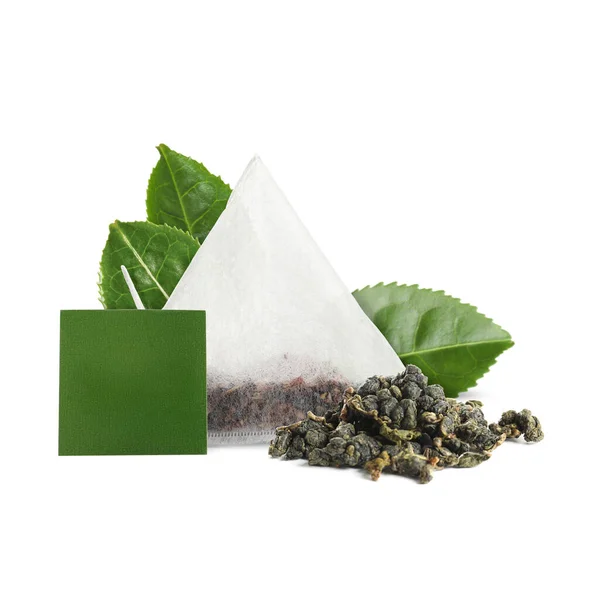 Tea bag with leaves on white background