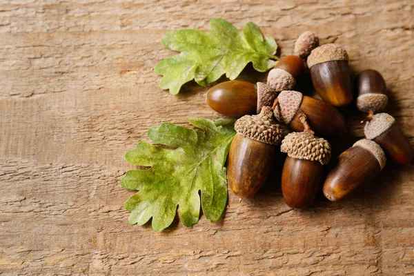 Pile Acorns Green Oak Leaves Wooden Table Space Text — Stock Photo, Image
