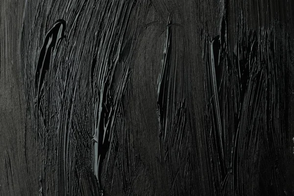 Beautiful strokes of black paint as background, closeup
