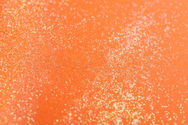 Turuncu arka planda parlak parlak parıltı, düz uzanmış.