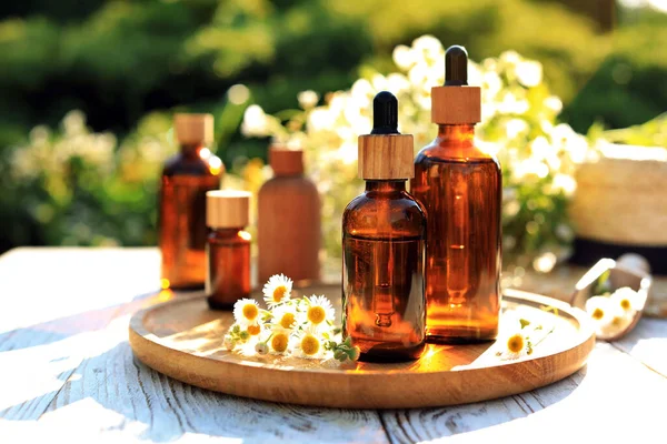 Bottles Essential Oil Flowers White Wooden Table Outdoors Space Text — Stock Photo, Image