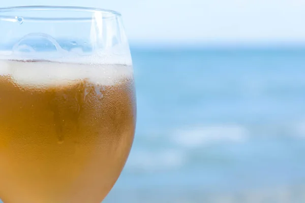 stock image Cold beer in glass on beach, closeup. Space for text