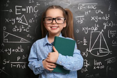 Cute little child wearing glasses near chalkboard with different formulas clipart