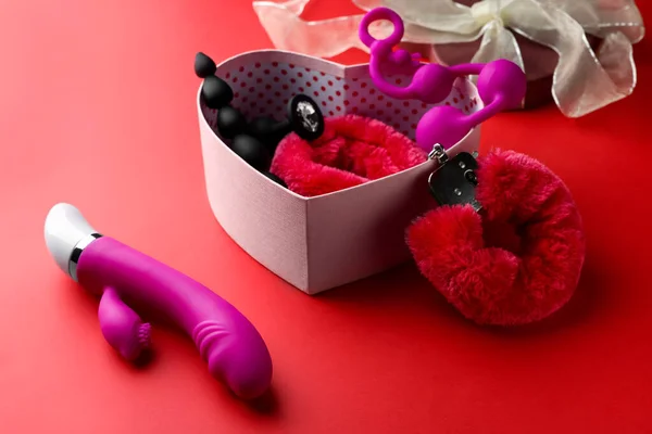 Caixa Presente Com Diferentes Brinquedos Sexuais Fundo Vermelho — Fotografia de Stock