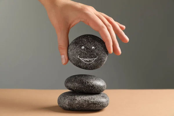 Woman Putting Stone Drawn Happy Face Stack Grey Background Closeup — Stock Photo, Image