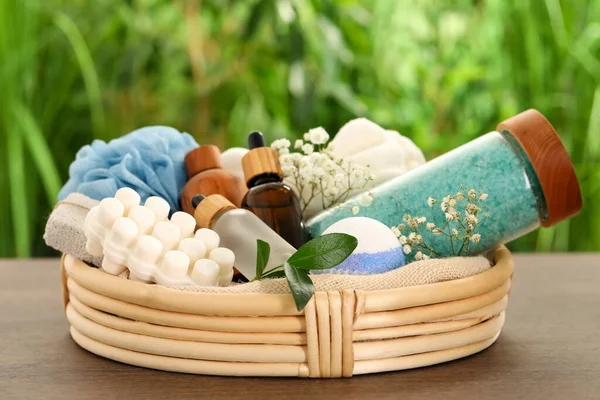 Spa gift set with different products on wooden table against blurred background