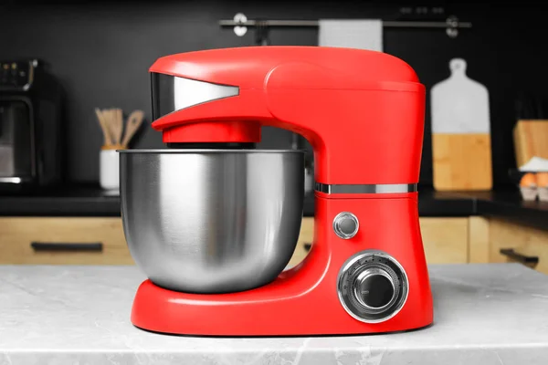 Modern stand mixer on table in kitchen. Home appliance