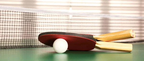 Rackets and ball on ping pong table indoors. Banner design