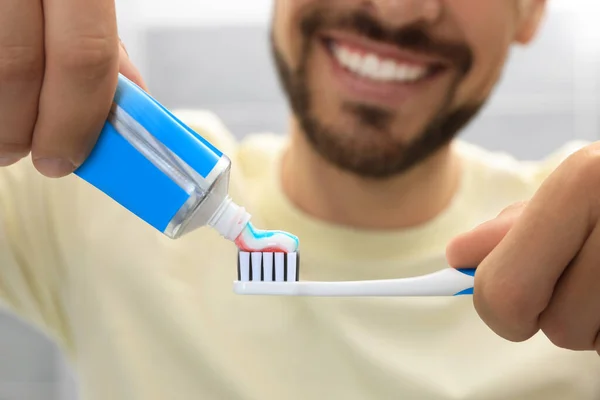 Man Applying Toothpaste Brush Blurred Background Closeup — Stock Photo, Image