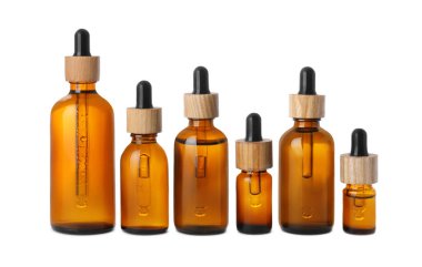 Row with different bottles of essential oil on white background