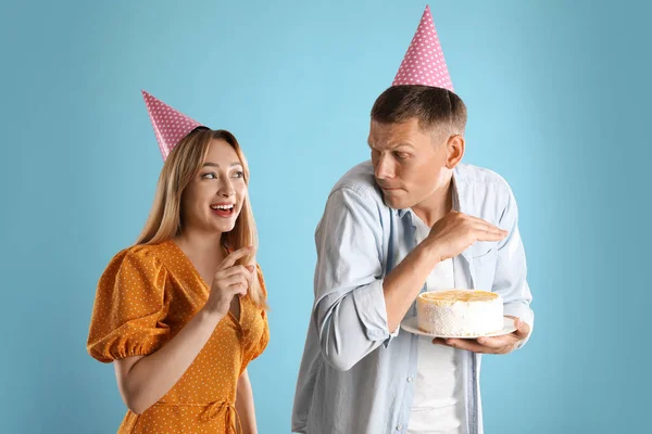 Greedy Man Hiding Birthday Cake Woman Turquoise Background — Stock Photo, Image