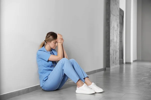 Exhausted Doctor Sitting Floor Hospital Space Text — Fotografie, imagine de stoc