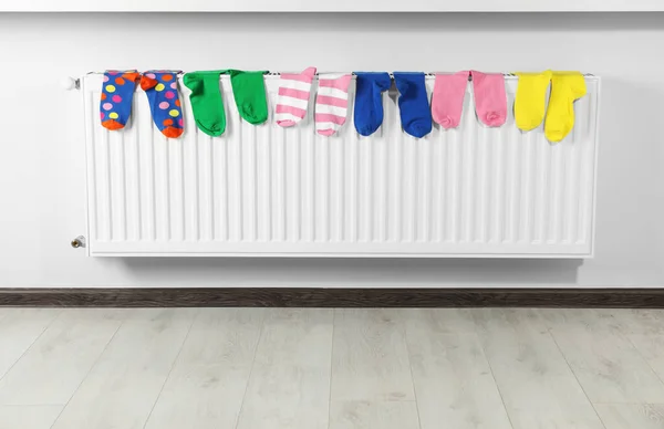 Different Colorful Socks Heating Radiator White Wall — Stock Photo, Image