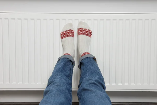 Woman Warming Legs Heating Radiator White Wall Closeup — Stock Photo, Image