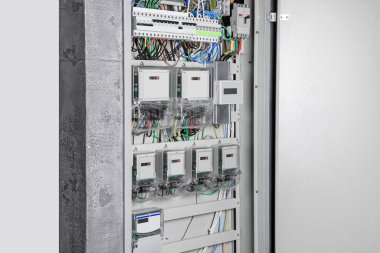 Elektrik sayaçları ve kabloları olan sigorta kutusu.