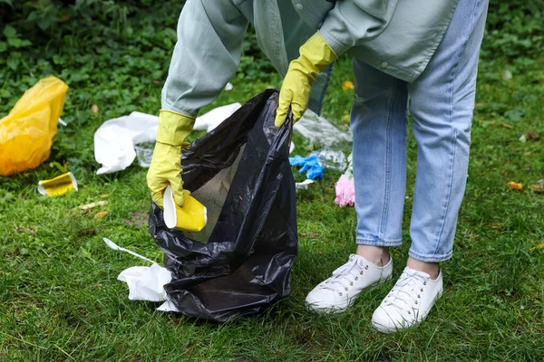 緑の芝生の屋外でゴミを収集ビニール袋を持つ女性 クローズアップ — ストック写真