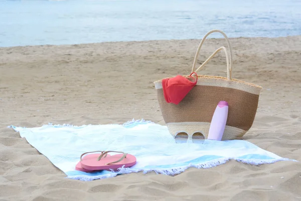 Light Blue Striped Towel Bag Flip Flops Sunglasses Sunblock Sandy — Stock Photo, Image