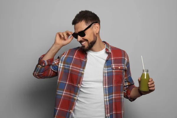 Happy Man Holding Bottle Delicious Juice Grey Background — Stock Photo, Image