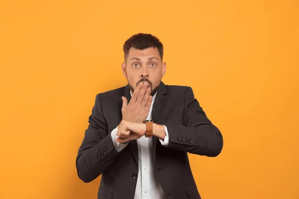 Emotional Man Checking Time Orange Background Being Late Concept — Foto Stock