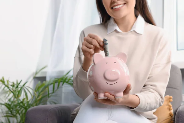 Feliz Jovem Mulher Colocando Dinheiro Porquinho Banco Casa Closeup — Fotografia de Stock