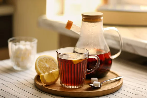 Stock image Aromatic tea with lemon and sugar on table