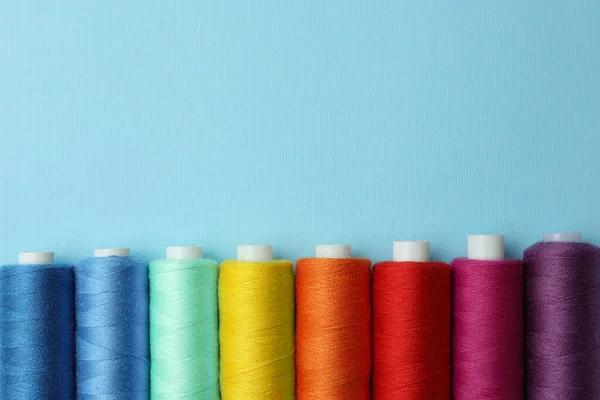 Set Different Colorful Sewing Threads Light Blue Background Flat Lay — Stock Photo, Image