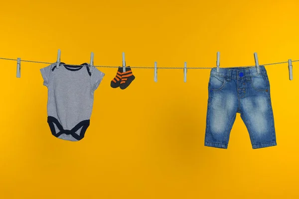 Různé Dětské Oblečení Sušení Prádelní Lince Oranžovém Pozadí — Stock fotografie