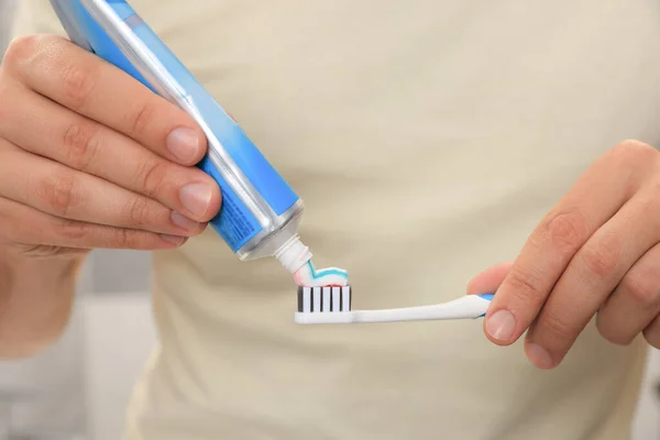 Man Applying Toothpaste Brush Blurred Background Closeup — 图库照片