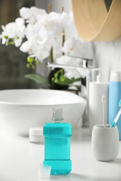 stock image Bottle of mouthwash on white countertop in bathroom
