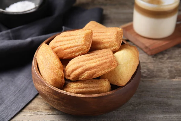 stock image Tasty madeleine cookies in bowl on wooden table