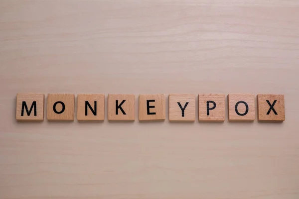 stock image Word Monkeypox made of squares on wooden table, top view