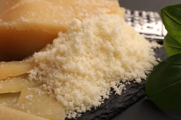 Delicious Grated Parmesan Cheese Black Slate Board Closeup — Foto de Stock