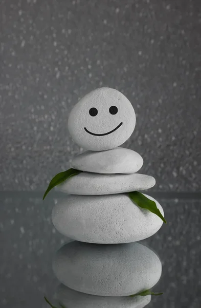 Stack Stones Drawn Happy Face Green Leaves Grey Background Zen — Stock Fotó