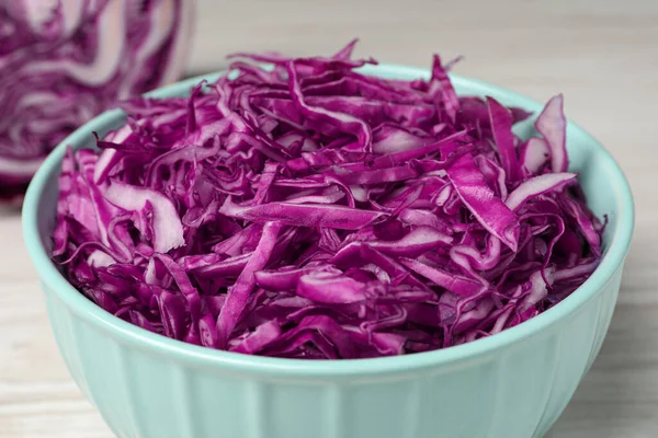 Tasty fresh shredded red cabbage in bowl, closeup