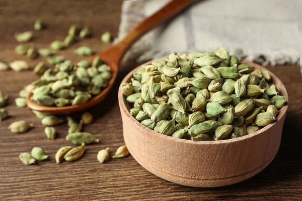 stock image Bowl of dry cardamom pods on wooden table