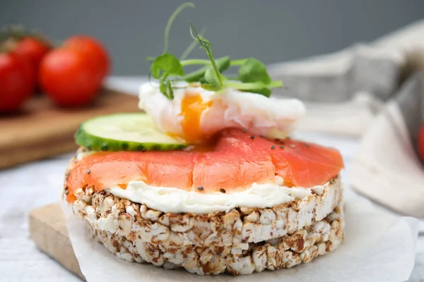 stock image Crunchy buckwheat cakes with salmon, poached egg and cucumber slices served on board, closeup