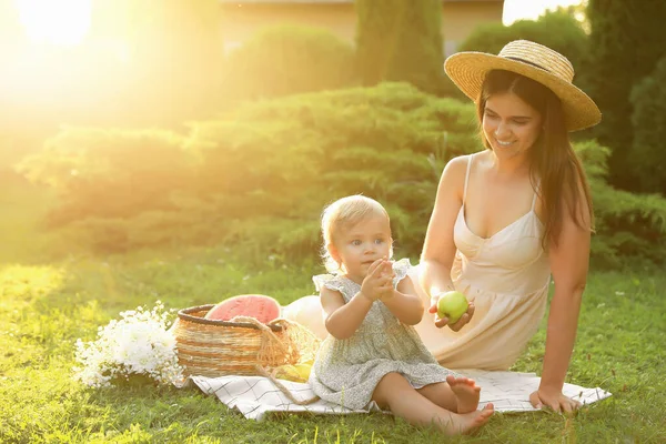 stock image Mother with her baby daughter having picnic in garden on sunny day