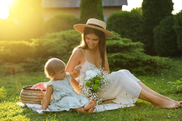 stock image Mother with her baby daughter having picnic in garden on sunny day