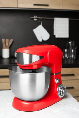 Modern stand mixer on table in kitchen. Home appliance