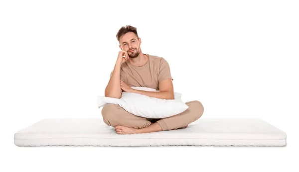 Hombre Con Almohada Sentado Sobre Colchón Suave Sobre Fondo Blanco —  Fotos de Stock