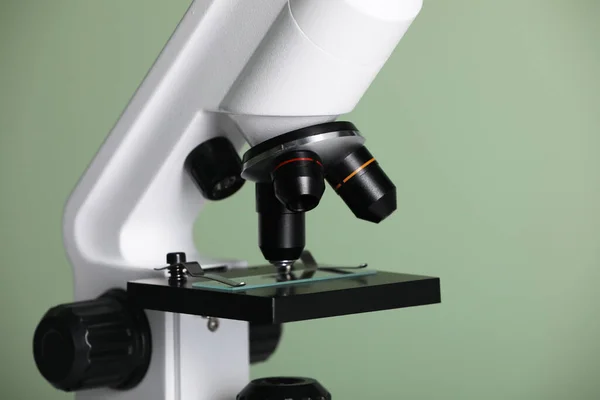 stock image Modern microscope on green background, closeup. Medical equipment