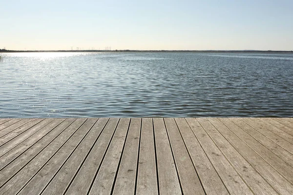 stock image Beautiful view of wooden terrace near river on sunny day