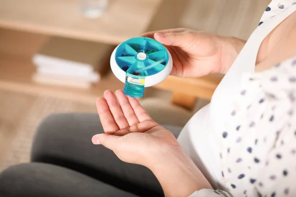 stock image Pregnant woman taking pill from container indoors, closeup