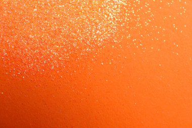 Turuncu arka planda parlak parlak parıltı, düz yatış. Metin için boşluk