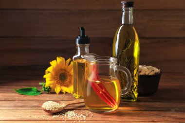 Different cooking oils and ingredients on wooden table