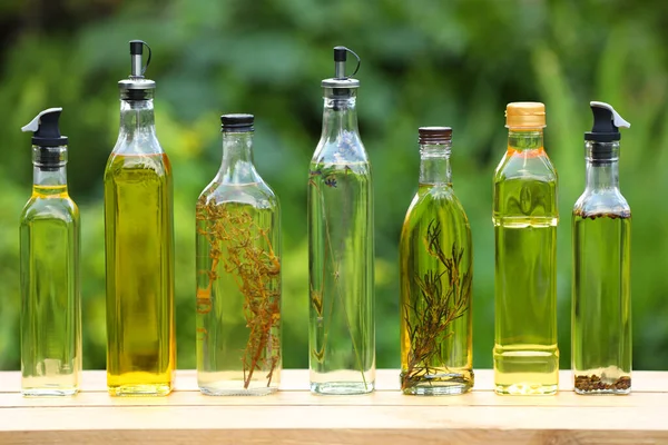 Many Different Cooking Oils Wooden Table Blurred Green Background — Stock Photo, Image