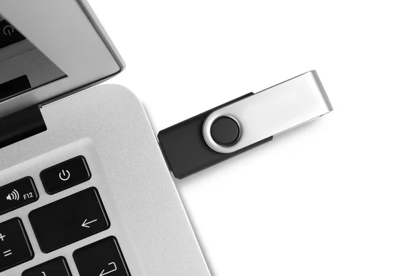 Stock image Modern usb flash drive attached into laptop on white background, top view